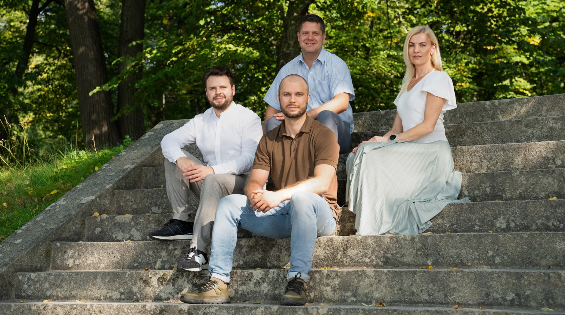 LAKKA Health team sitting together on stone steps