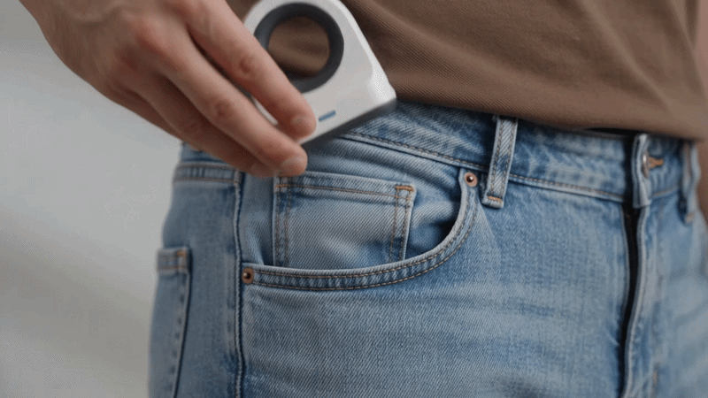 Siiring finger blood pressure monitor sliding easily into a jeans pocket